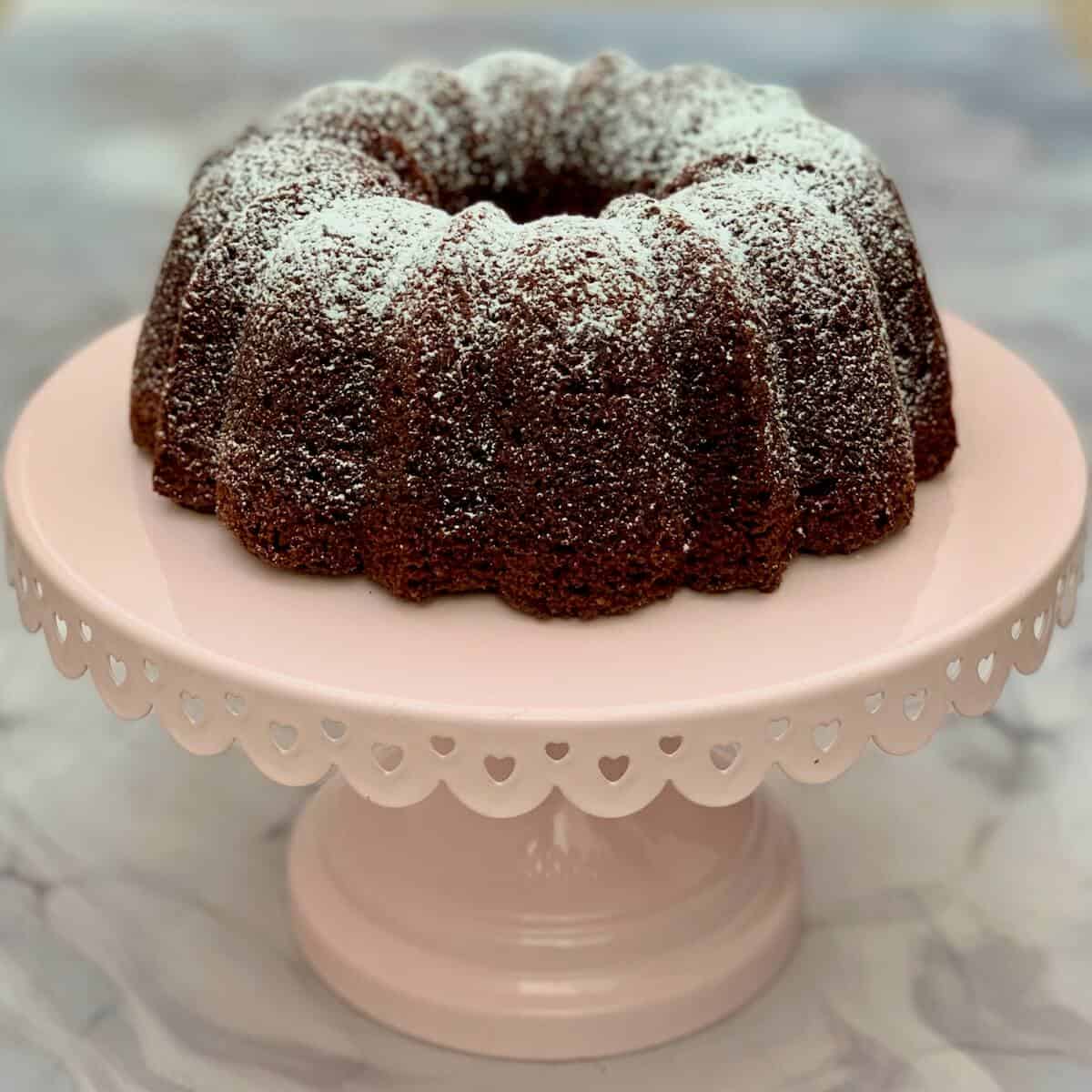 Whole Kahlua Cake on a pink cake stand.