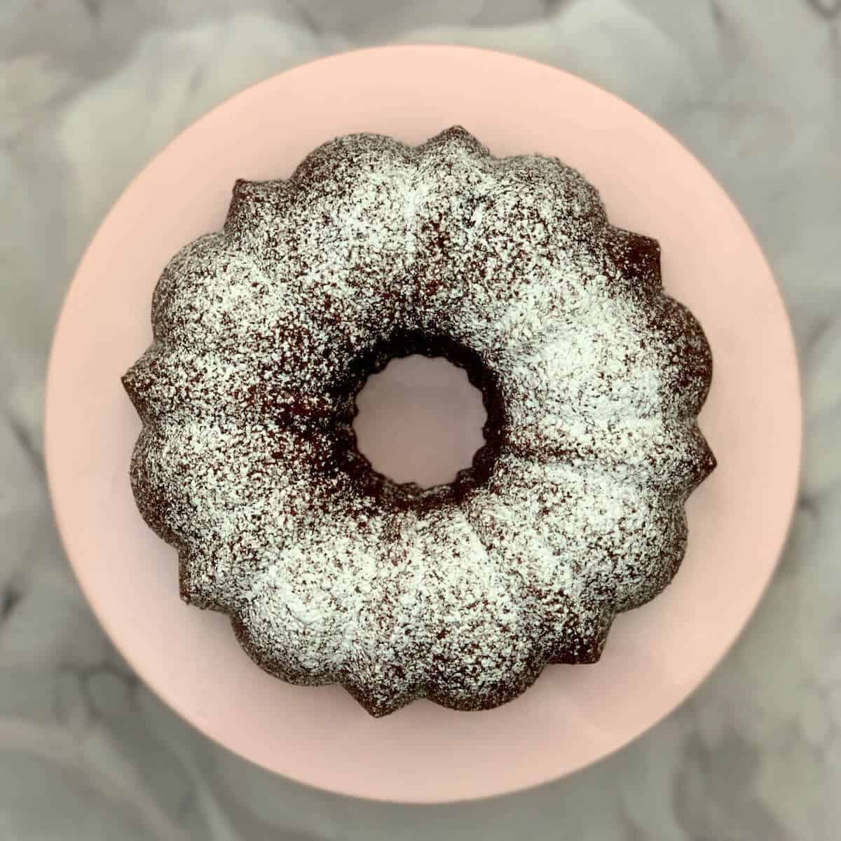 Kahlua Cake on a pink cake stand from overhead.