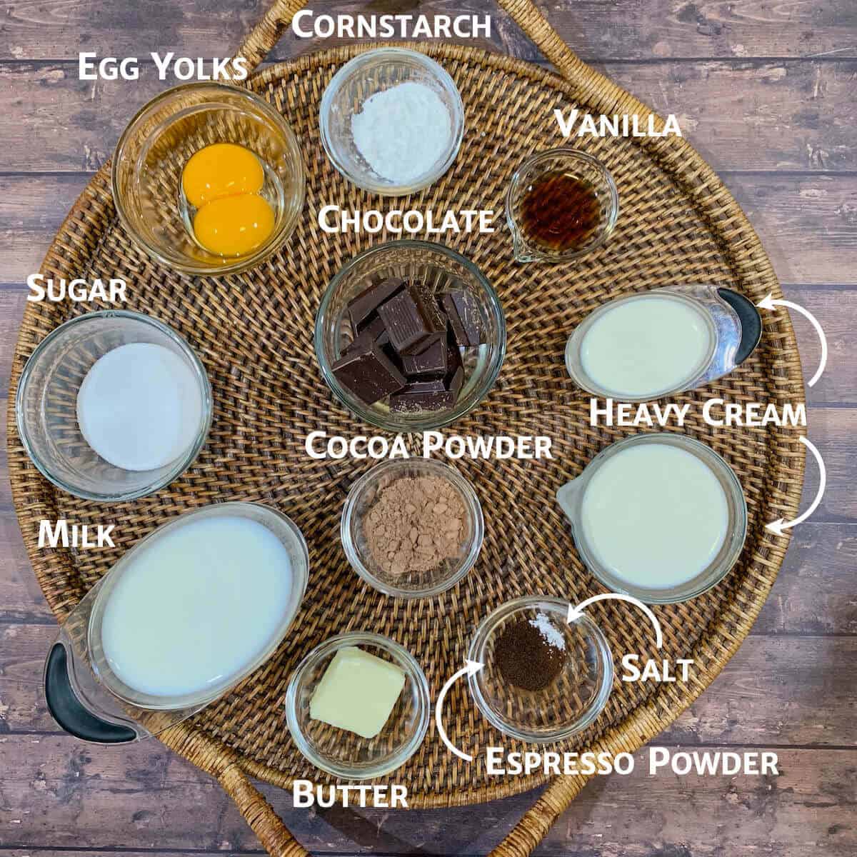 Chocolate Cream Pie ingredients portioned into glass cups on a wooden tray.