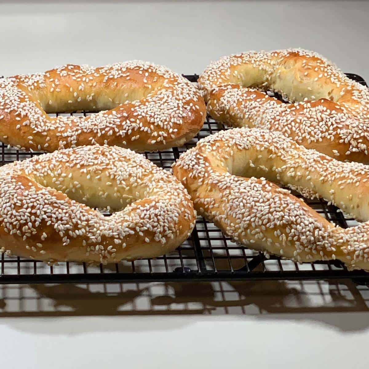 Baked Sourdough Jerusalem Bagels cooling on a wire rack.