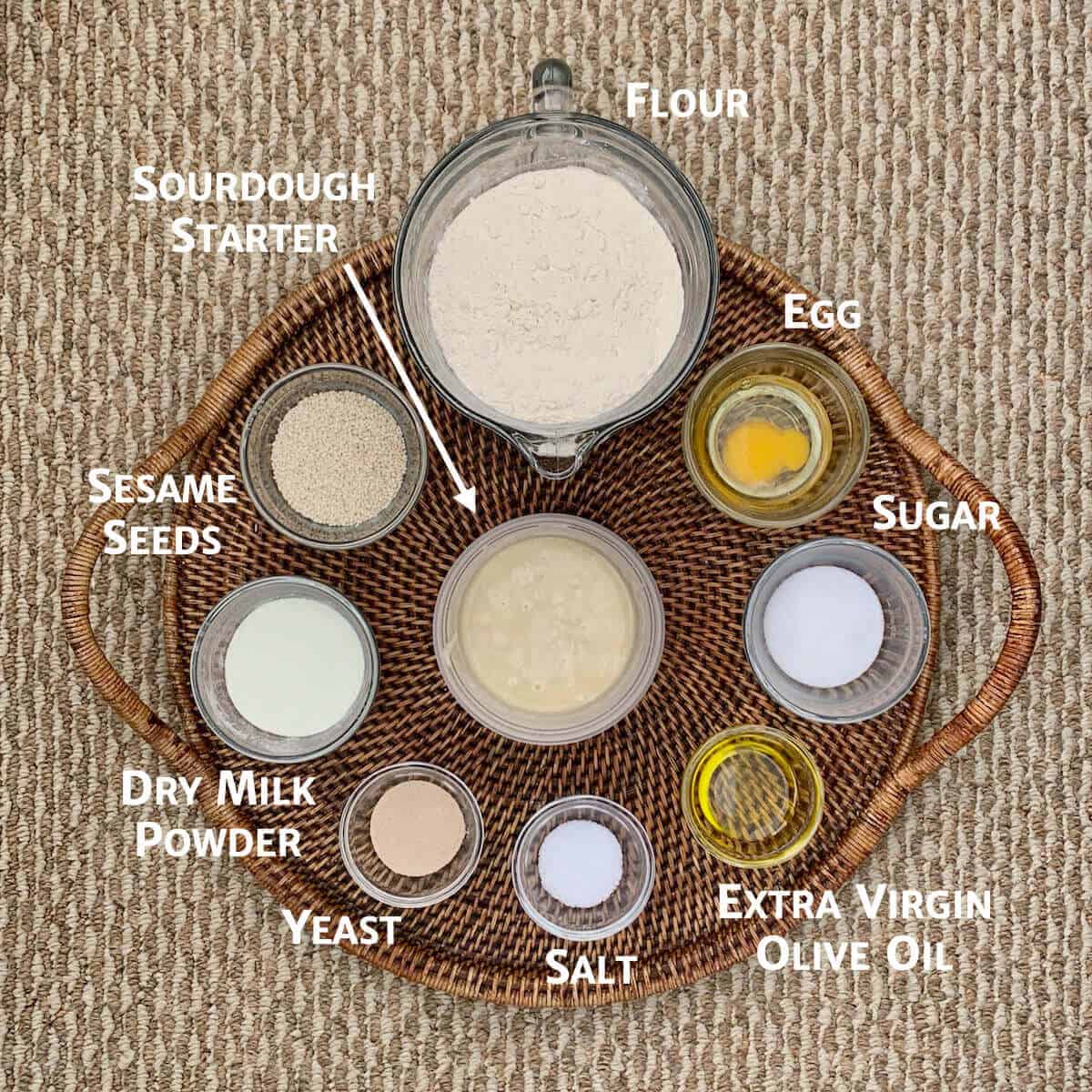 Sourdough Jerusalem Bagel ingredients on a wooden tray portioned into glass bowls from overhead.