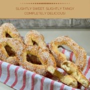 Sourdough Jerusalem Bagels with one broken in half in a basket lined with a red & white striped towel Pinterest banner.