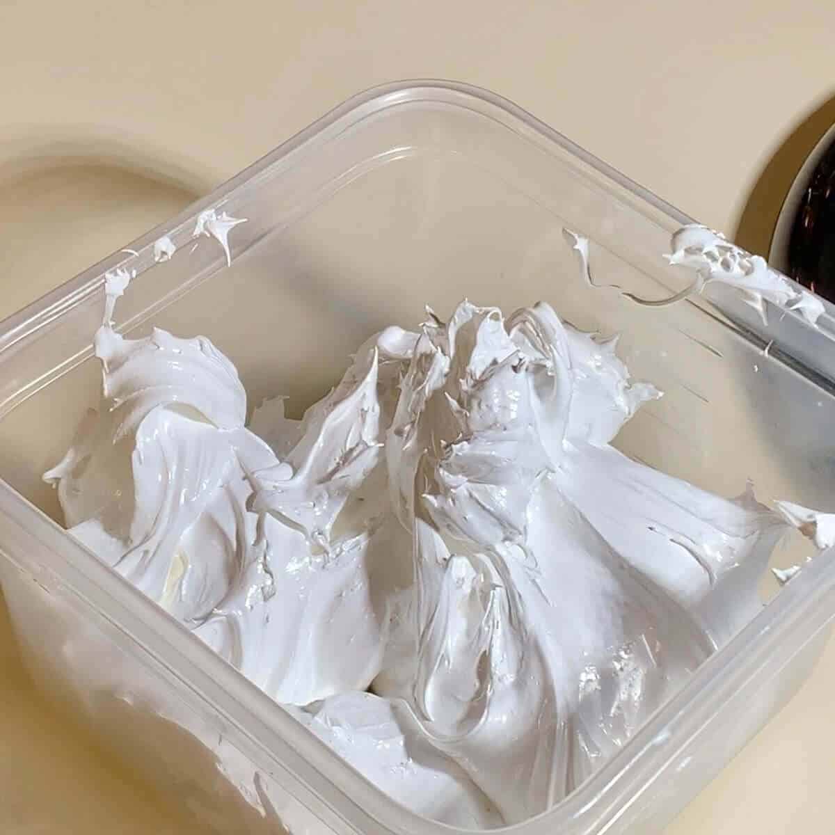 Marshmallow creme in a container on the counter.