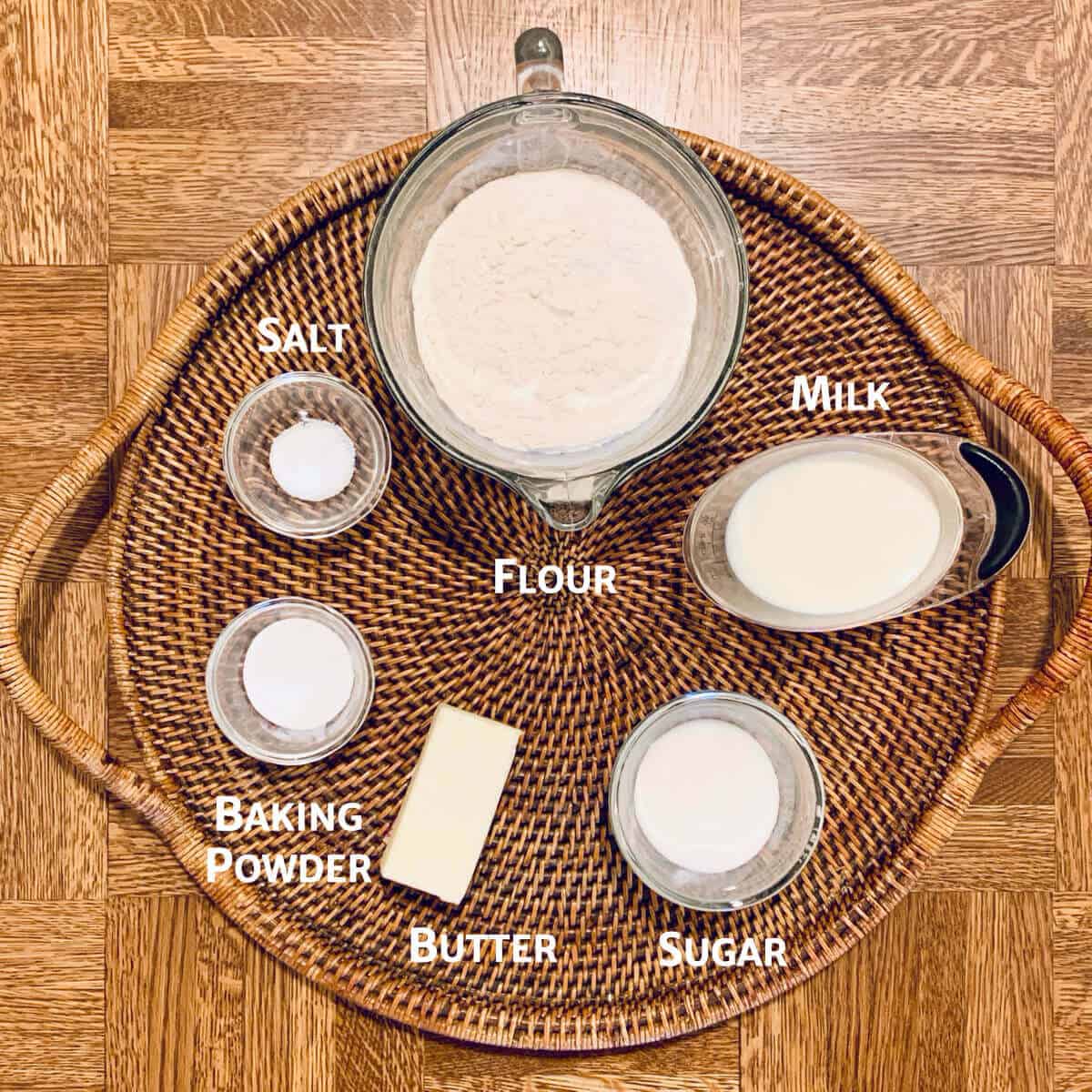 Shortcake biscuit ingredients on a woven tray.