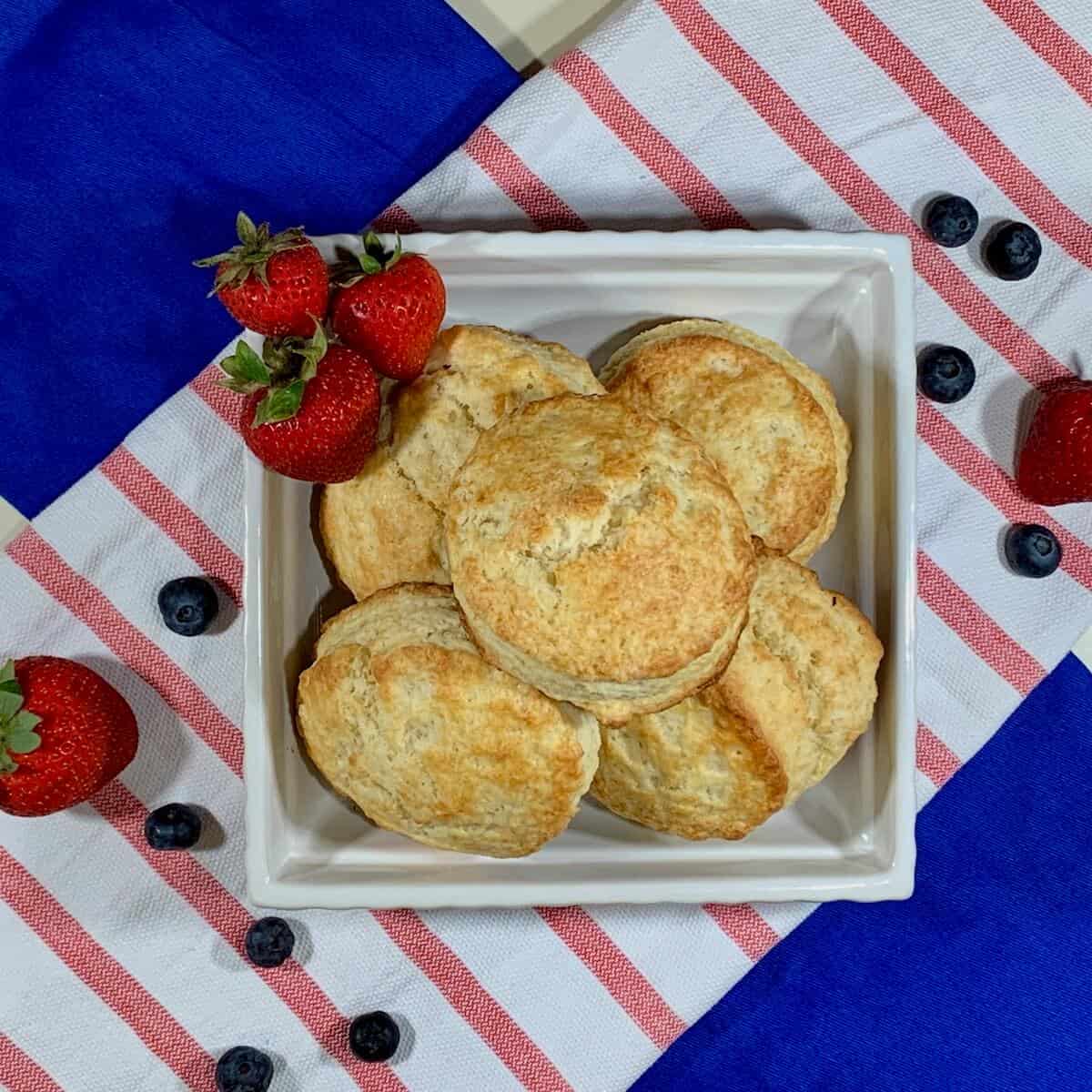 Strawberry Blueberry Shortcakes stacked & plated on a red striped towel from overhead.