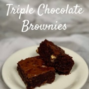 Two Triple Chocolate Brownies stacked on a white plate Pinterest banner.