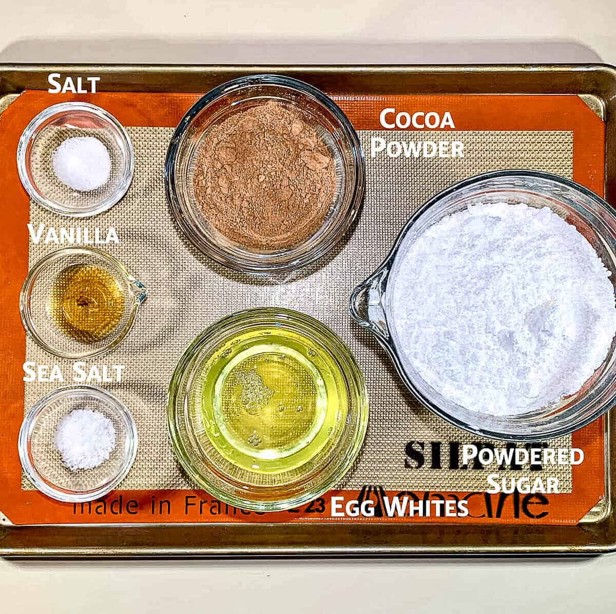 Flourless chocolate cookie ingredients on a baking tray.