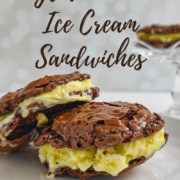 Two Gluten-Free Ice Cream Sandwiches stacked white plate with one on a glass cake stand behind Pinterest banner.