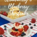 Strawberry Blueberry Shortcake plated on red striped towel Pinterest banner.