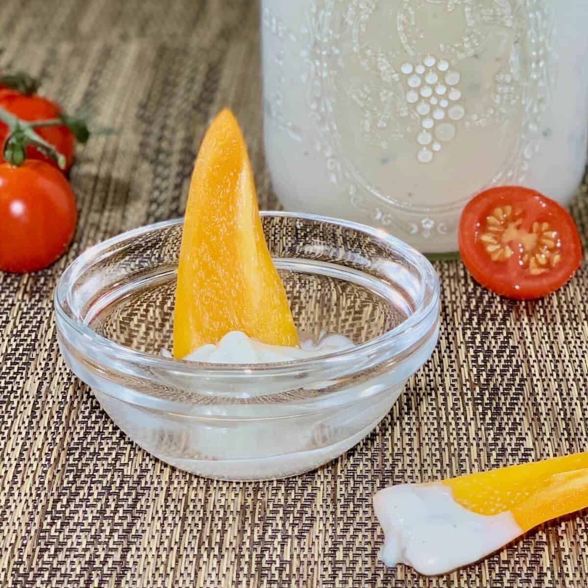 Closeup of yellow pepper dipped in buttermilk blue cheese dressing.