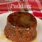 Sticky Toffee Pudding on a white plate on plaid napkin Pinterest banner.