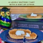 Treacle Tart sliced & plated on blue plate with tart on green plate on book & glass owl in background Pinterest banner.