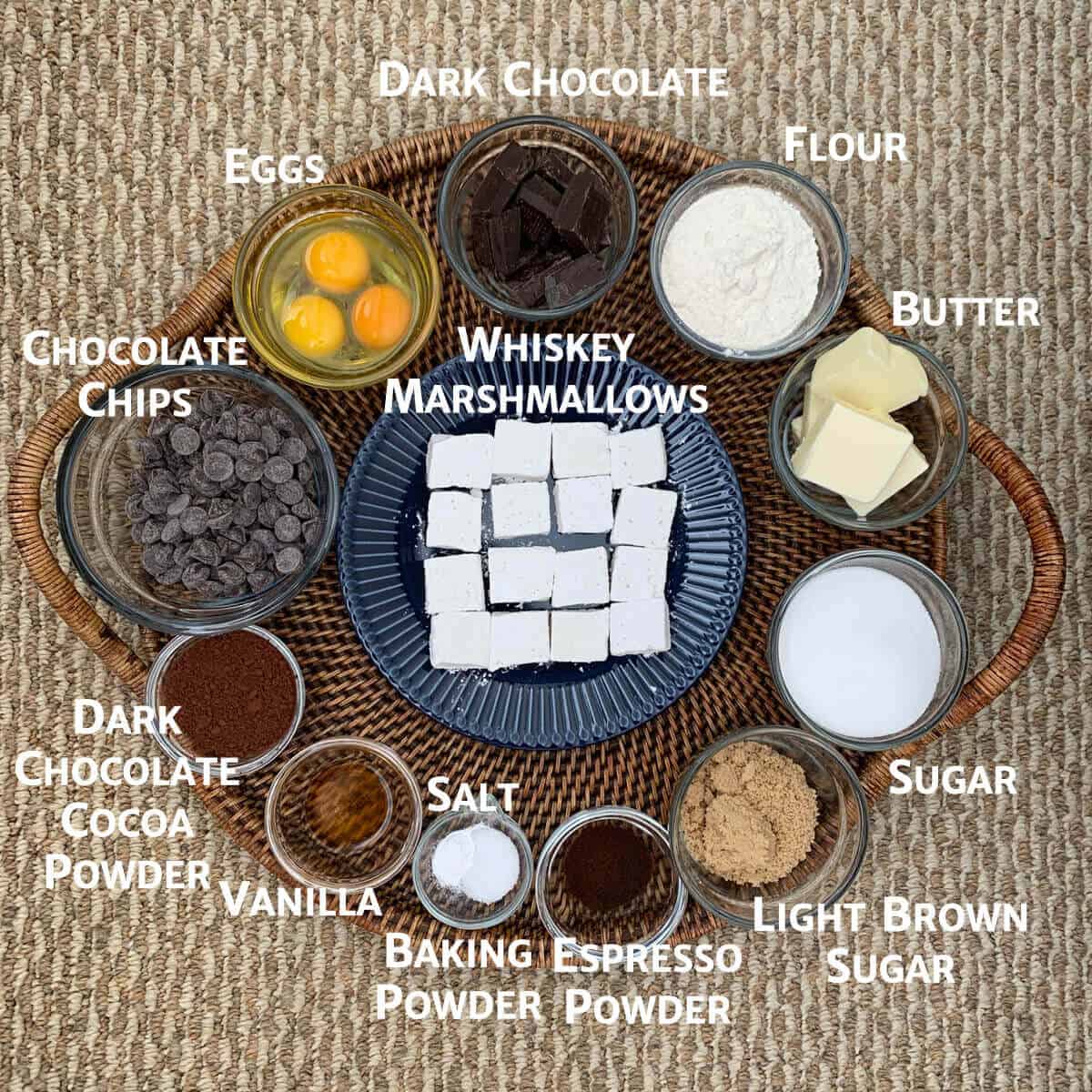 Whiskey Marshmallow Brownie ingredients portioned into bowls on a woven tray.
