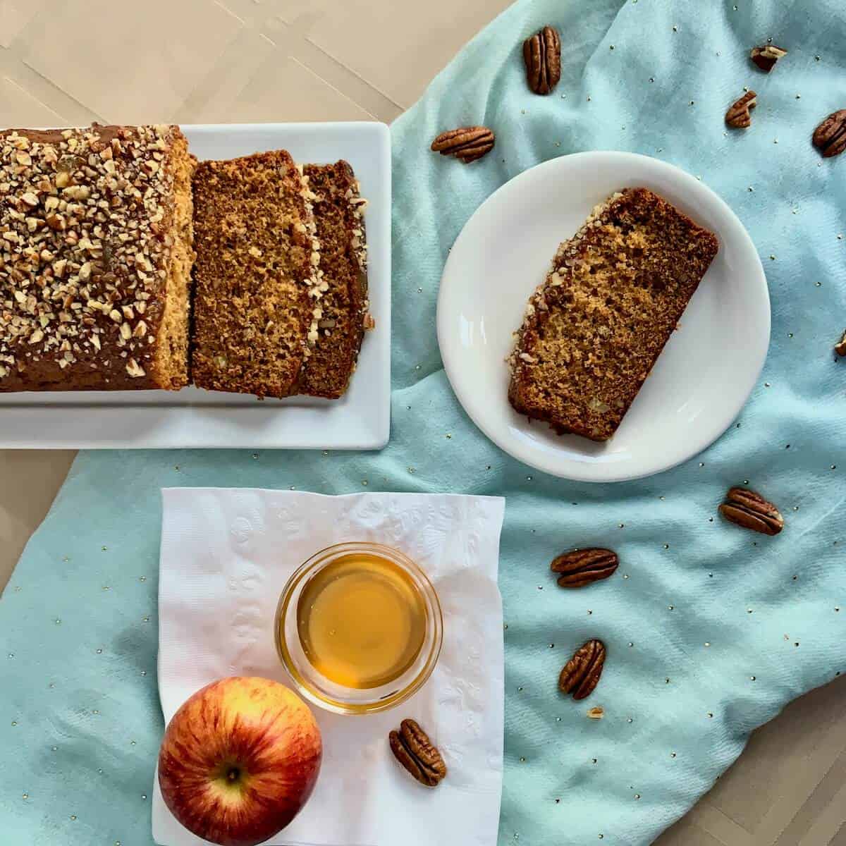 Honey Cake sliced & plated with apples & honey from overhead.