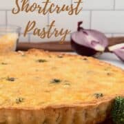 Chicken Broccoli Quiche on a gold base with cheese & red onion Pinterest banner.