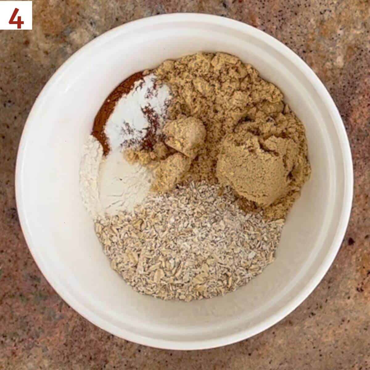Flour, sugar, rolled oats, cinnamon, baking powder, and salt in a bowl.