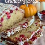 Glazed Orange Cranberry Bread sliced on a white plate with pumpkins & cranberries Pinterest banner.