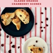 Orange Cranberry Scones plated on white plate & stacked on blue plate from overhead Pinterest banner.