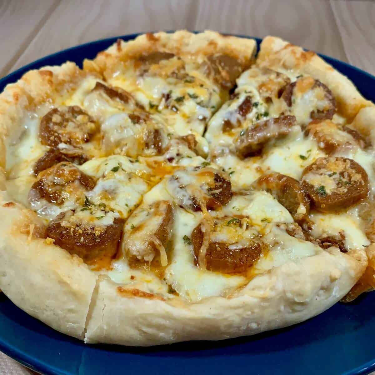 Sliced sourdough pizza on blue plate.
