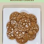 Molasses cookies stacked on white plate from overhead Pinterest banner.