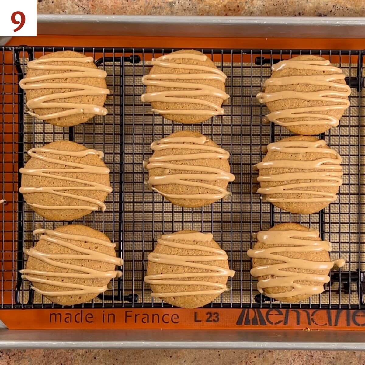 Glazed apple spice cookies on a cooling rack.