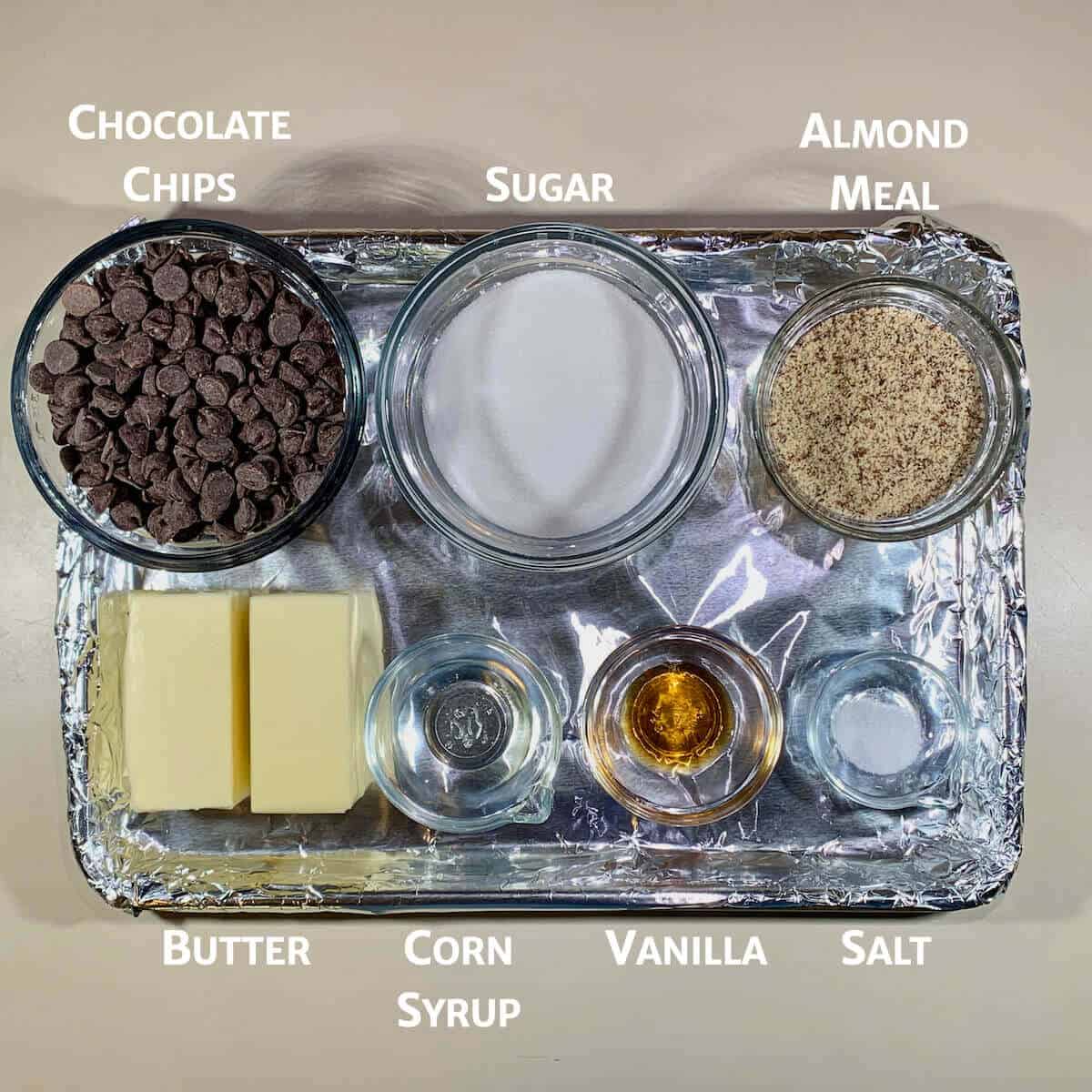 English Toffee ingredients portioned into glass bowls on a foil-lined tray.