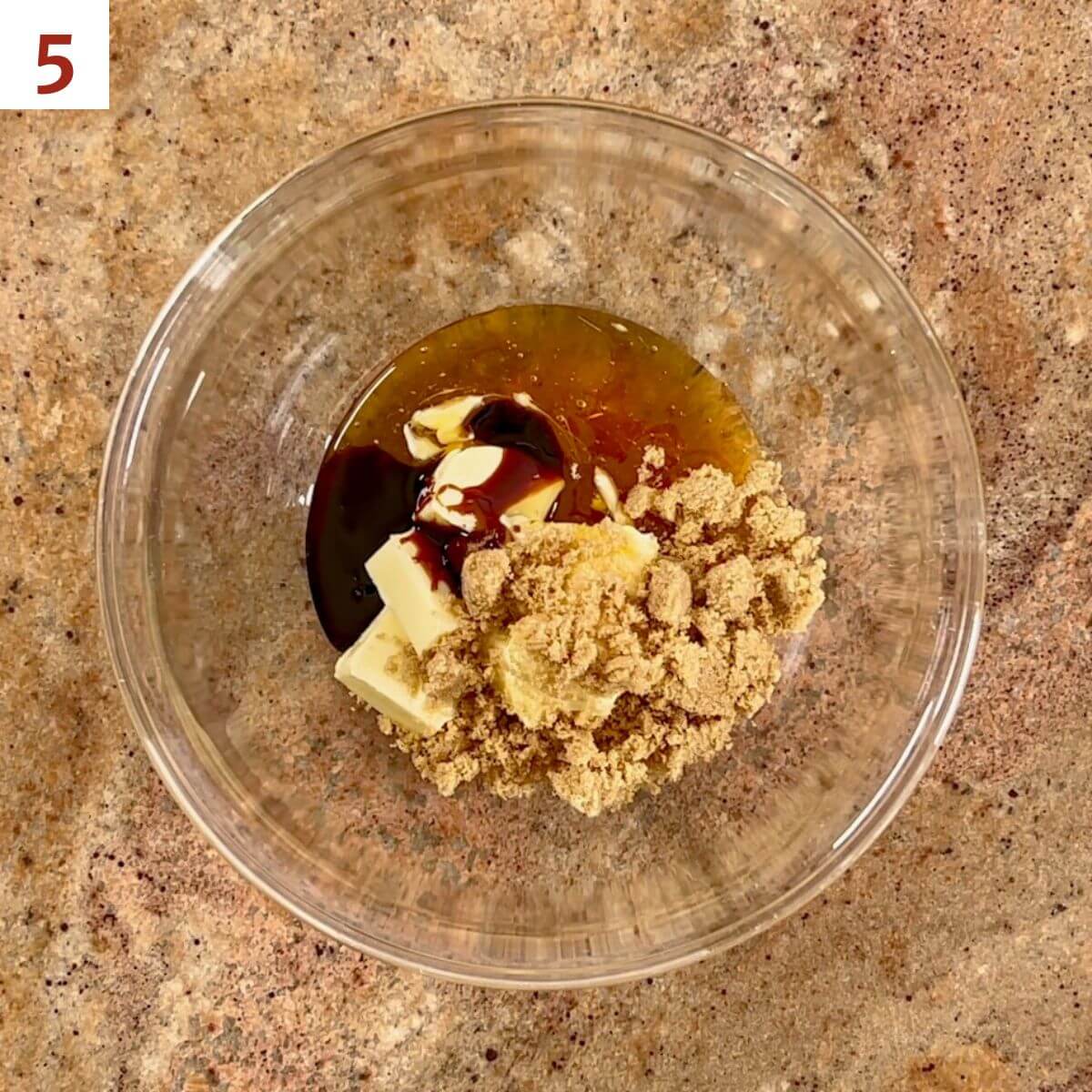 Butter, brown sugar, honey, and molasses in a glass bowl from overhead.