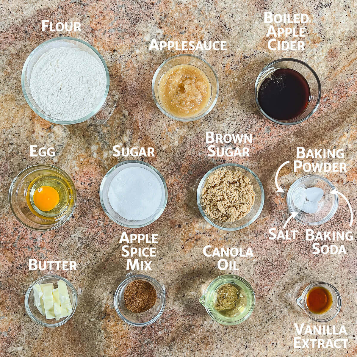 Ingredients for apple spice cookies portioned into glass bowls from overhead.