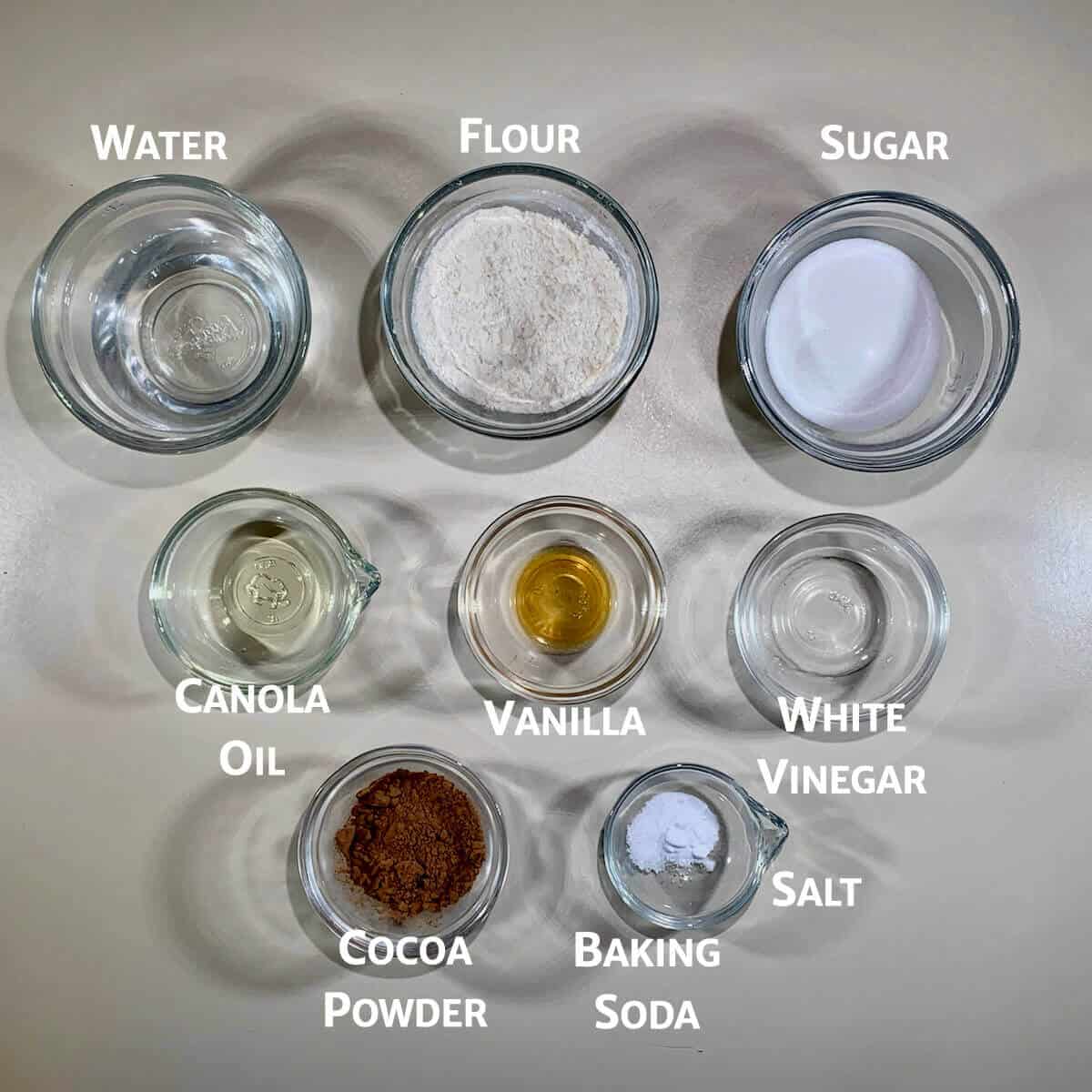 Chocolate Mug Cake ingredients portioned into glass bowls.