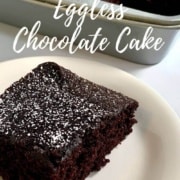 Piece of chocolate cake on a white plate with sliced cake in background Pinterest banner.