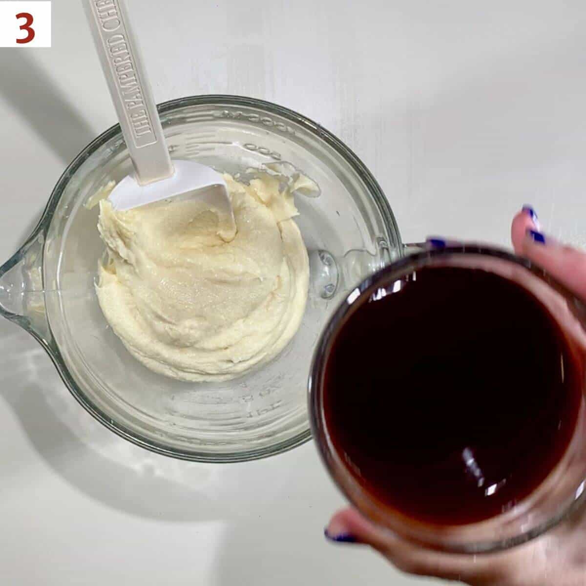 Adding chocolate syrup to cake batter.