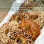 Assorted sourdough bagels on a white towel in a basket Pinterest banner..