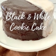 Whole Black & White Cookie Cake on a white cake stand Pinterest banner.