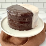 Whole Black & White Cookie Cake on a white cake stand.