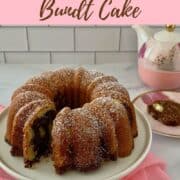 Marble Bundt Cake on cake stand sliced with piece on plate & teapot in background Pinterest banner.