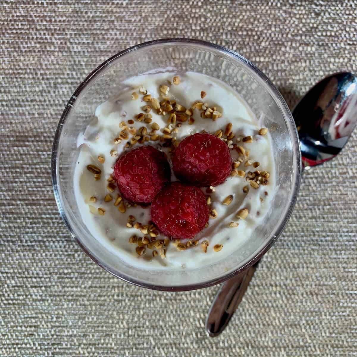 Cranachan top layer with a spoon from overhead.