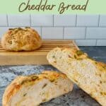 Sourdough Jalapeño Cheddar Bread sliced open closeup with loaf behind on cutting board Pinterest banner.