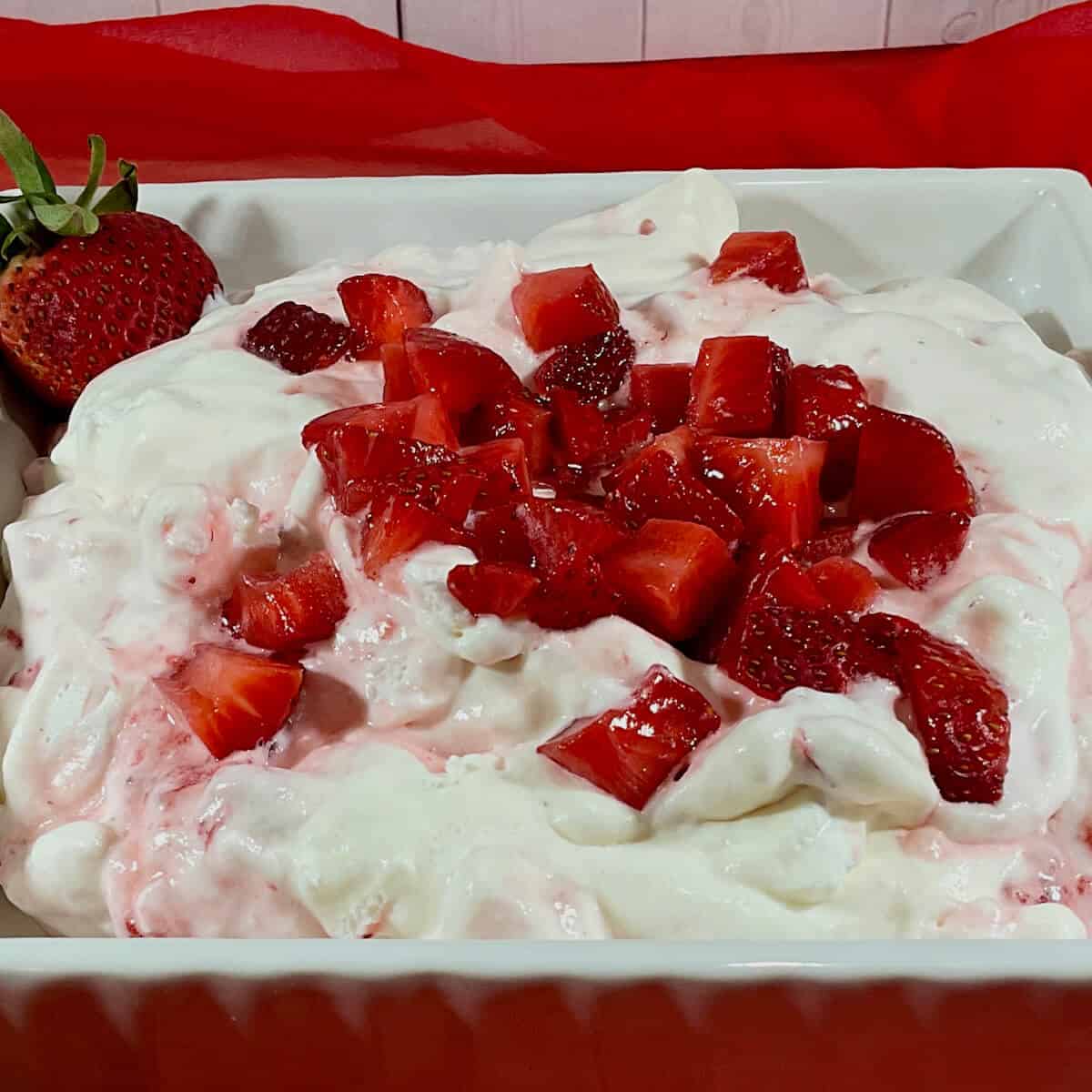 Eton Mess in a bowl on red scarf closeup