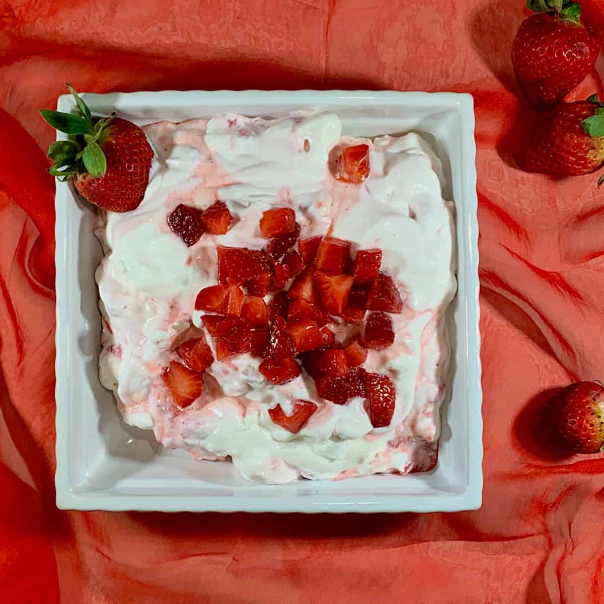 Eton Mess in a bowl on red scarf from overhead