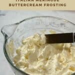 Italian Meringue Buttercream in glass bowl with some lifted on spatula Pinterest banner.