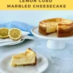 Lemon Curd Marbled Cheesecake slice on white plate with cheesecake on white cake stand & forks & lemons in background Pinterest banner.