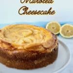 Lemon Curd Marbled Cheesecake on white cake stand with forks & lemons in background Pinterest banner.