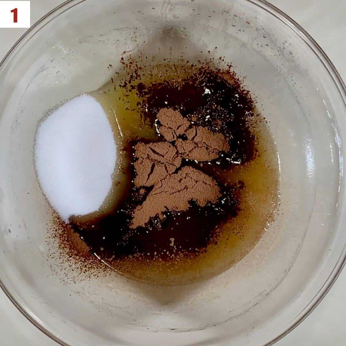 Melted butter, cocoa powder, sugar, and salt in glass bowl.