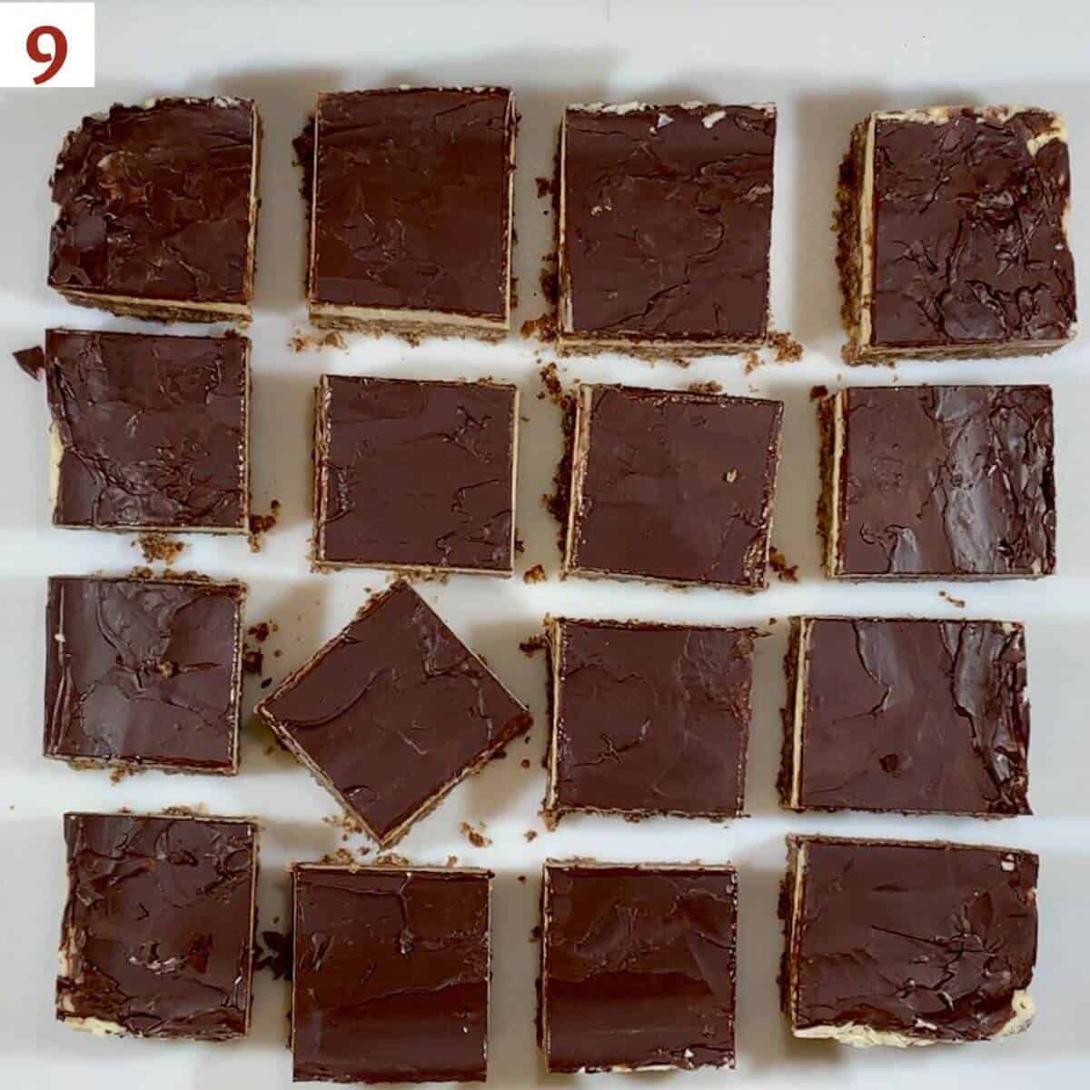 Nanaimo bars cut into squares on a cutting board from overhead.