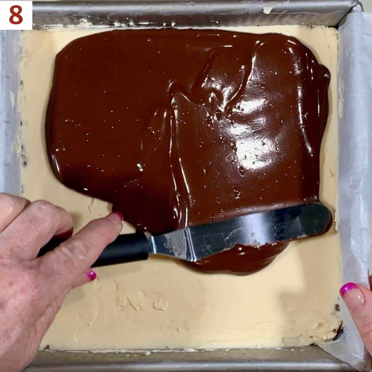 Spreading the chocolate layer on the filling.