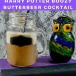 Butterbeer in a mason jar next to a glass owl on a book Pinterest banner.