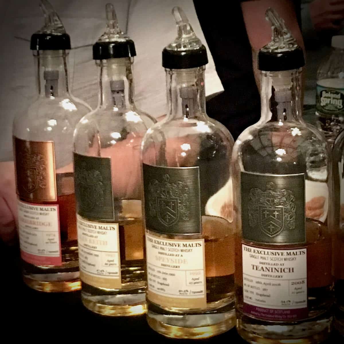 Some of the Exclusive Malts bottles on a table.