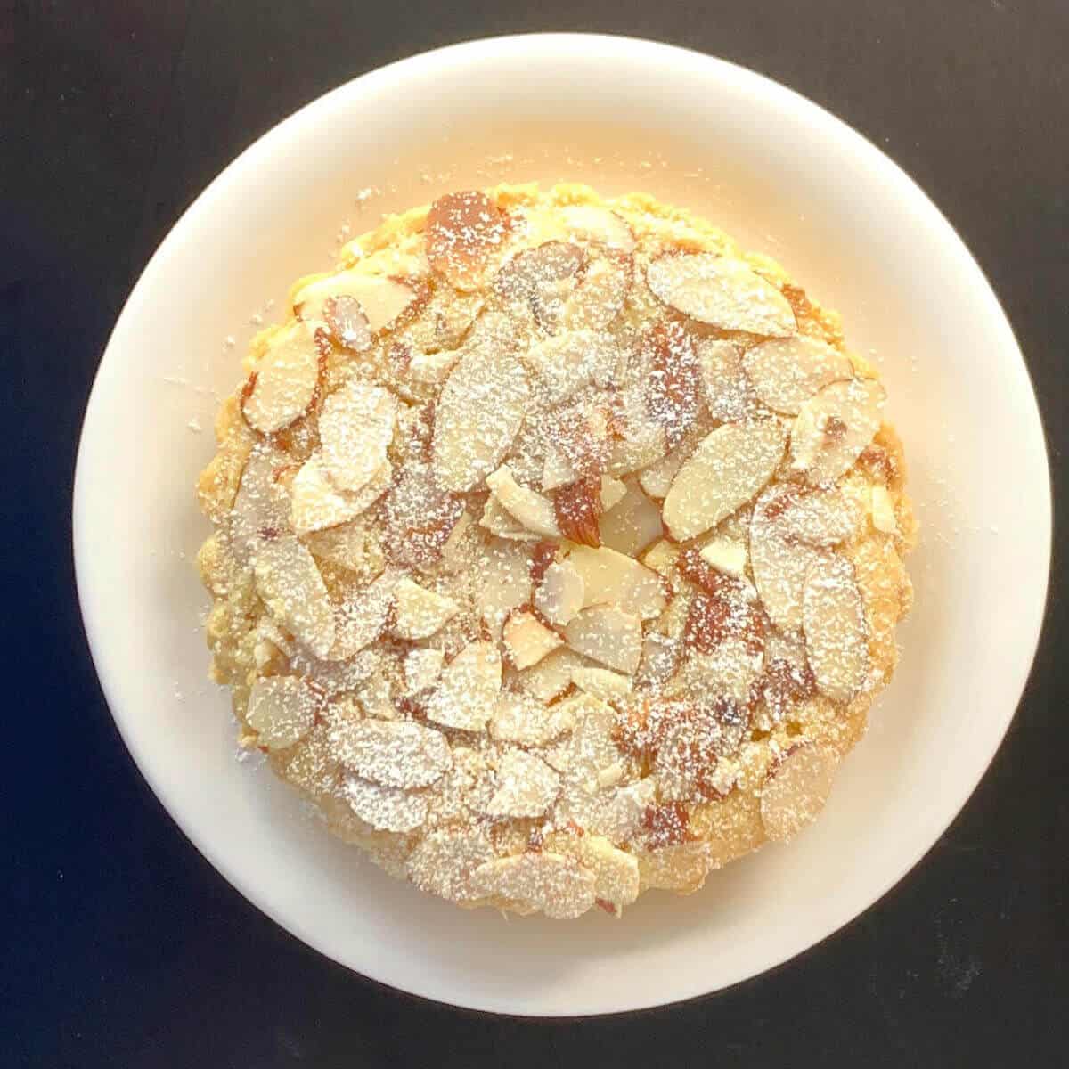 Mini Bakewell Tart on a white plate from overhead.