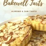 Three mini Bakewell tarts on a white cake stand Pinterest banner.