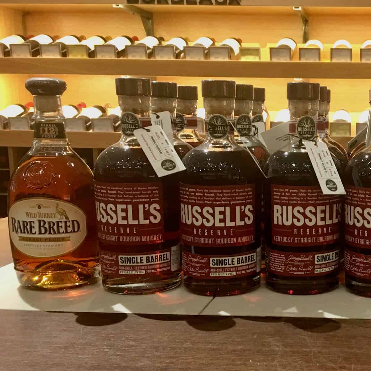 Wild Turkey Rare Breed & Gordon's Private Barrel Picks from Russell's Reserve on a counter.